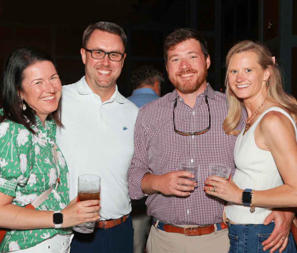 four guests with bourbon glasses at Bourbon & Bites event