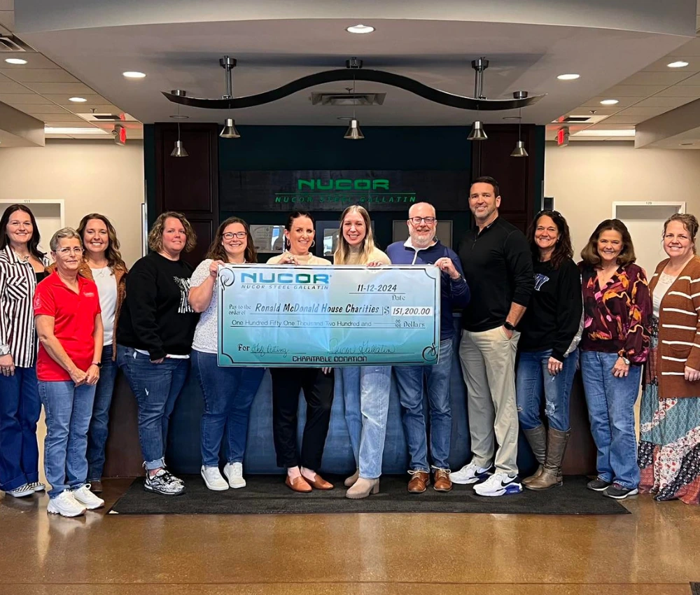 Corporate partner presenting a large donation check to Ronald McDonald House