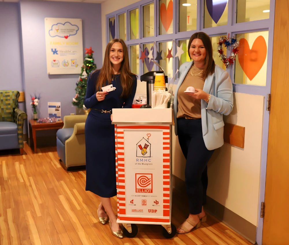 two volunteers working to deliver goods with the care cart