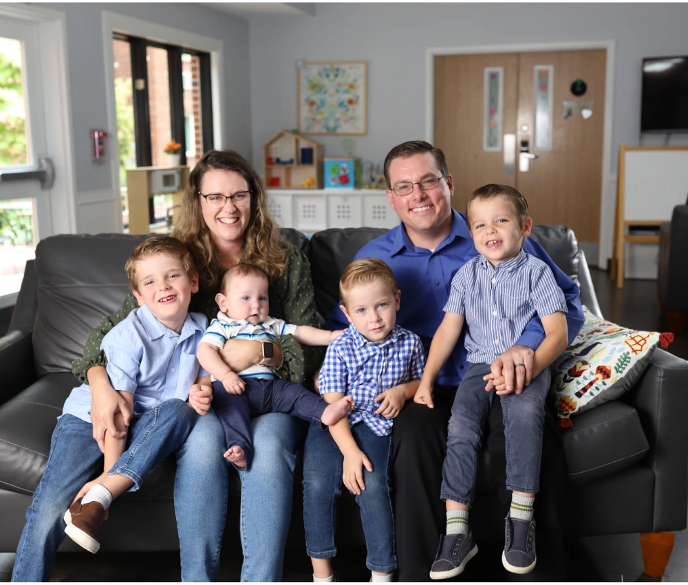 David Lorimer with his family sitting together on a couch