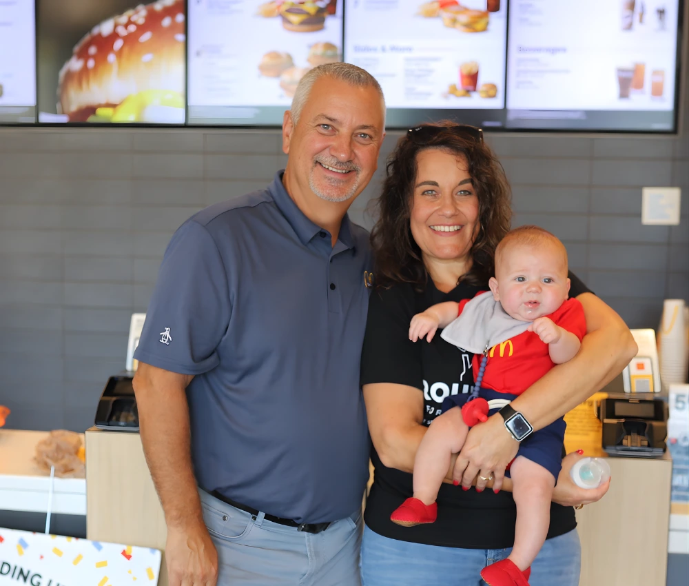 mother and father with young baby at mcdonald's restaurant