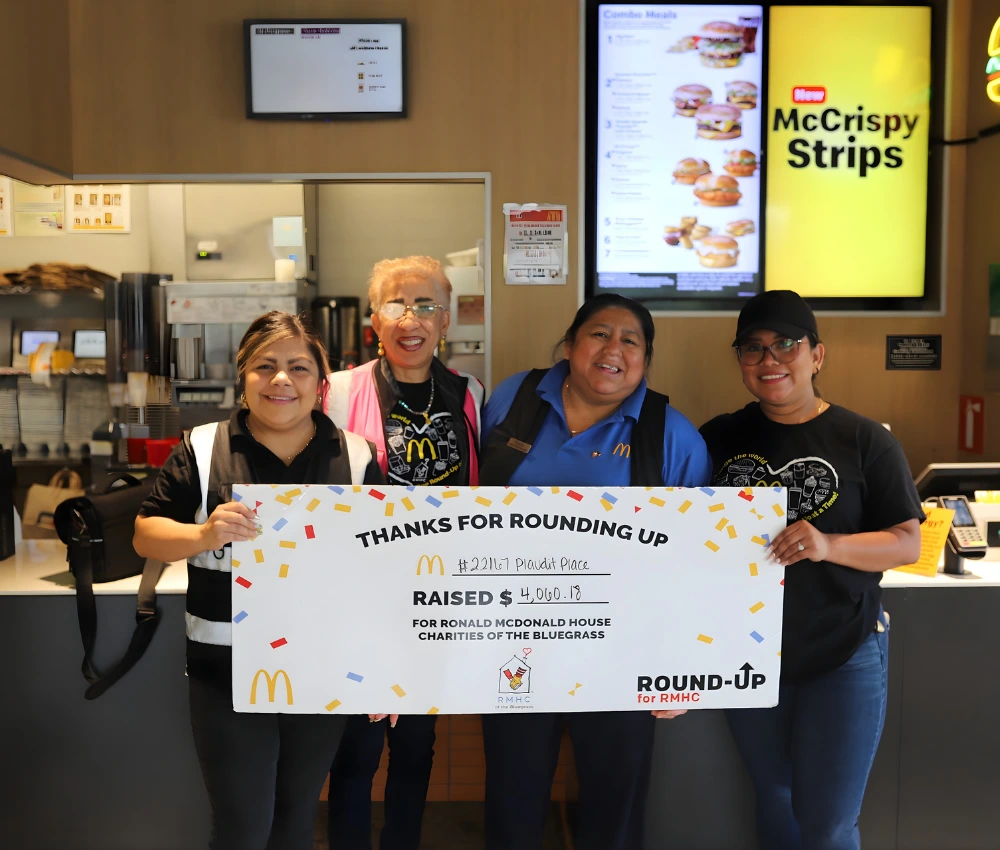 McDonalds restaurant staff presenting a round up check donation